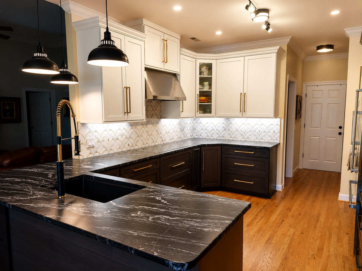 Completed Brown Dog Builders kitchen with cream upper cabinets, dark lower cabinets, and stone countertops